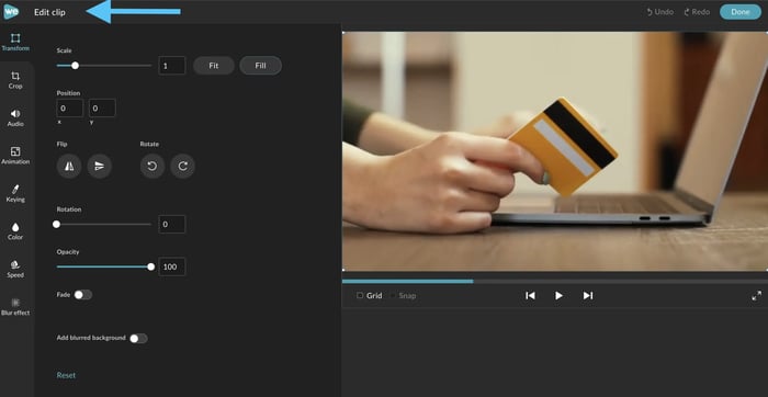 Edit menu in WeVideo showing how to adjust clip of a hand holding a credit card by a computer